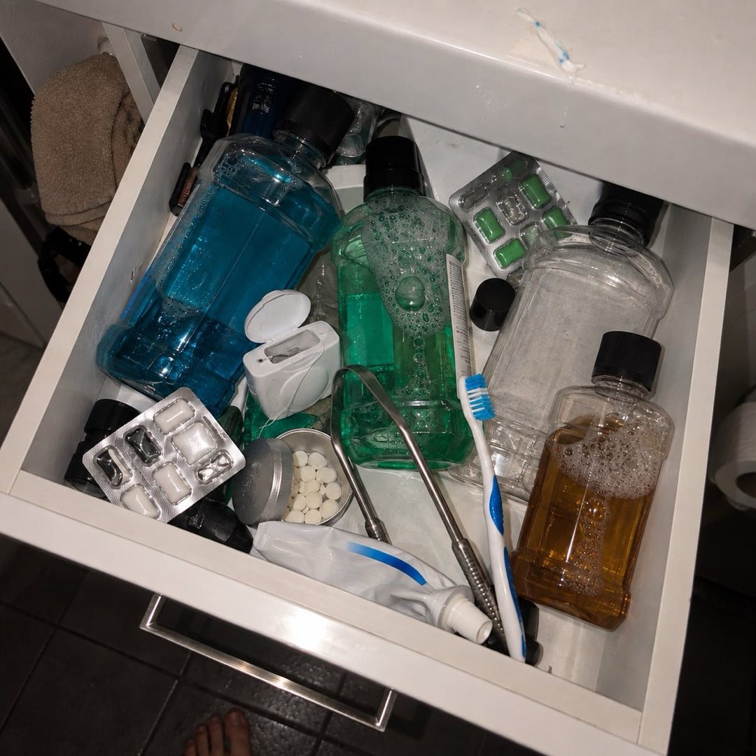 A bathroom drawer crammed with half-used mouthwash, gum and mints.